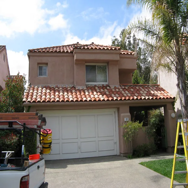 Same two-story tile-roof house after cleaning