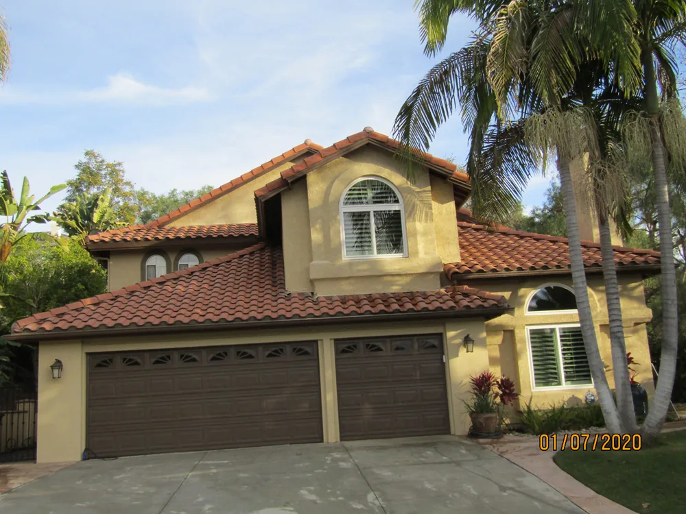 Clean tile roof among mature trees used to illustrate foothill access and foliage planning.